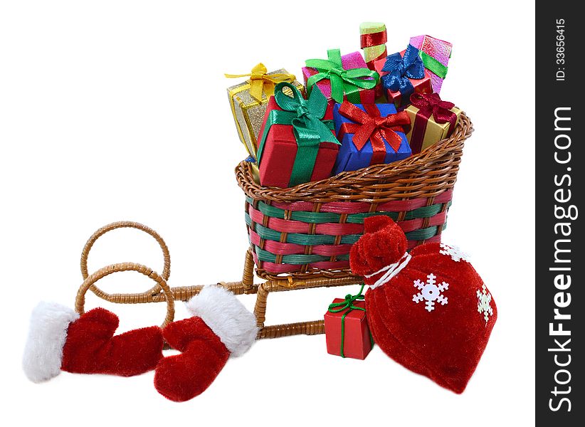 Toy Santas sledges with colorful gifts, red bag and furry mittens isolated. Toy Santas sledges with colorful gifts, red bag and furry mittens isolated