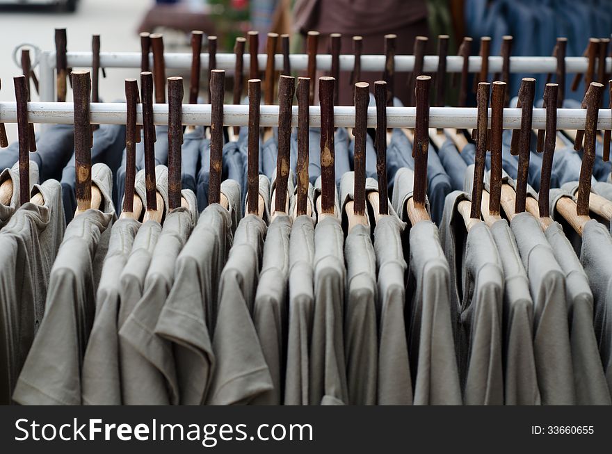 Rows of clothes and wood coat hanger