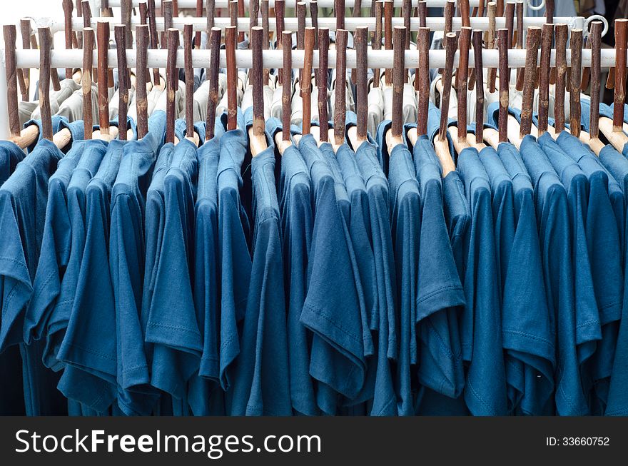 Rows of clothes and wood coat hanger