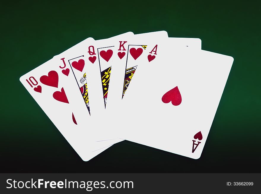 Playing cards on dark green background