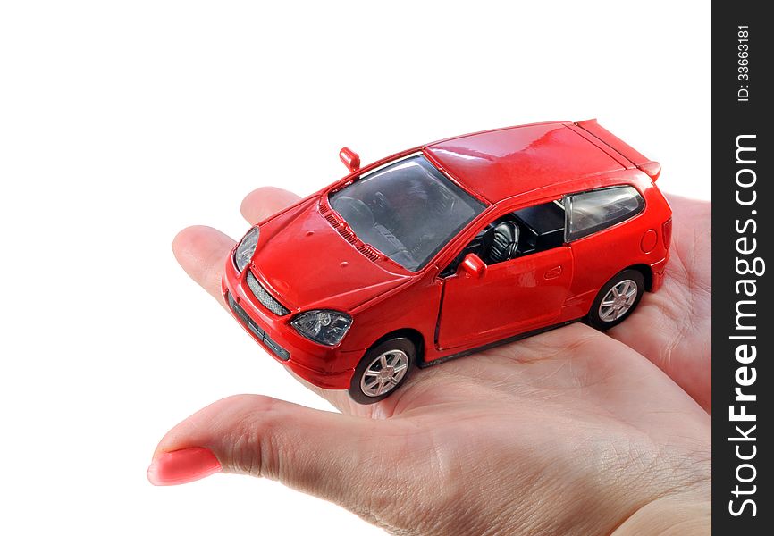 Salesperson holding the toy of a brand new red car. Salesperson holding the toy of a brand new red car