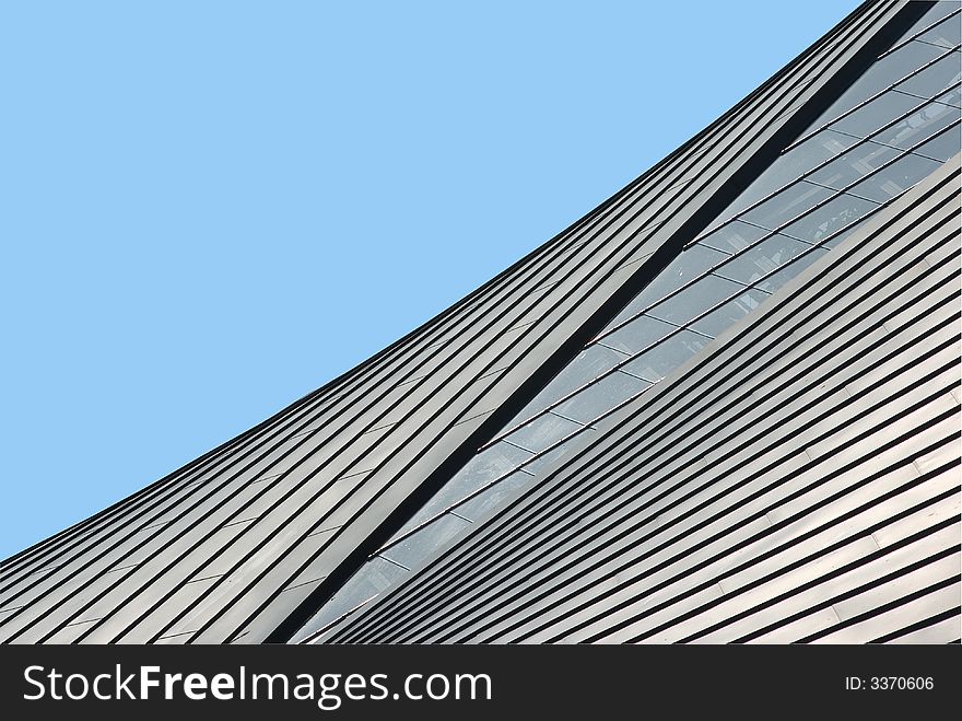 Angular roof lines against a clear blue sky