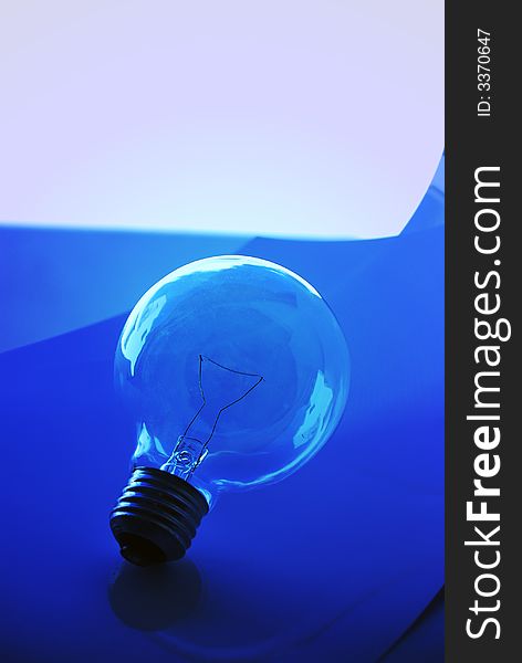 Light Bulb over blue composition over a white background. Light Bulb over blue composition over a white background