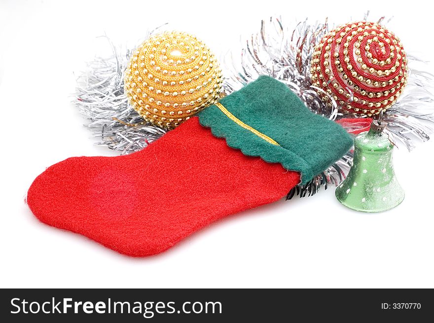 Photograph of Christmas stocking on white background with Christmas tree decorations.