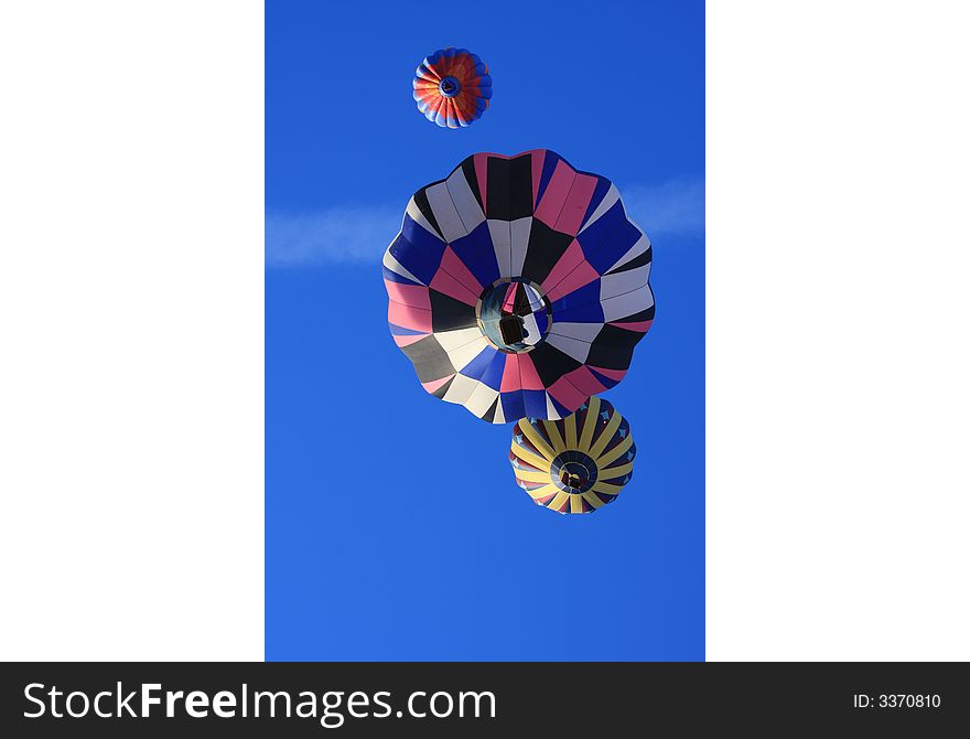 Three hot air balloons directly overhead. Three hot air balloons directly overhead.