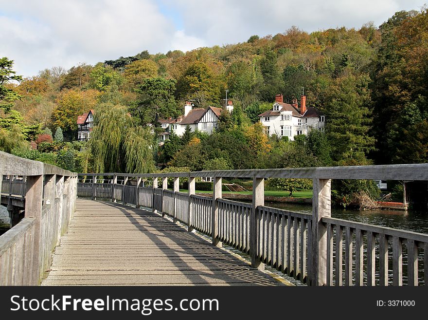 Early Autumn on a wooden footbridge over the River Thames. Early Autumn on a wooden footbridge over the River Thames