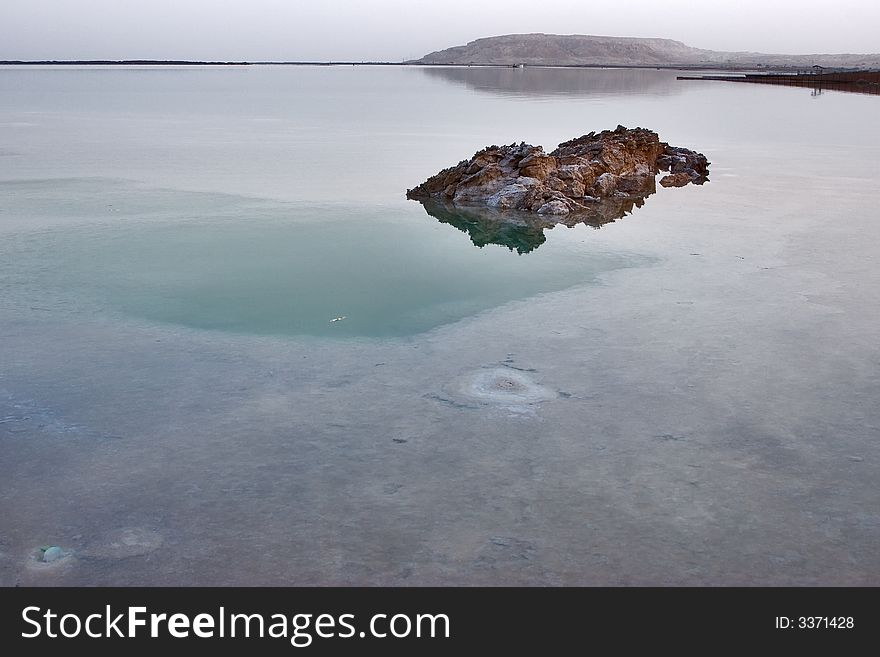 A stone in the shoaled salty Dead Sea. A stone in the shoaled salty Dead Sea