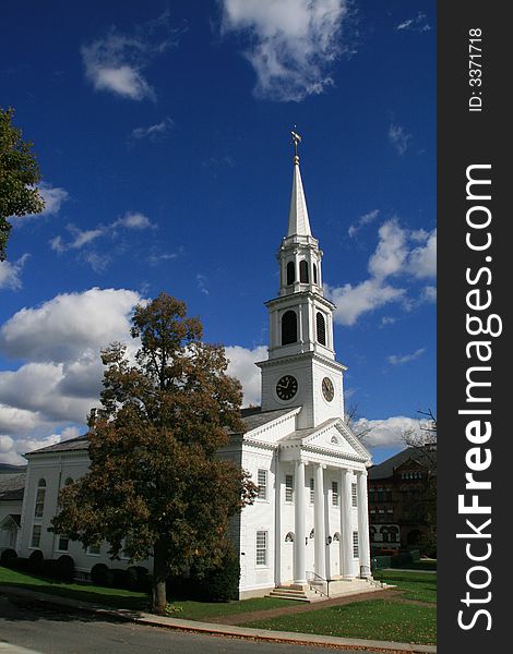 White church on a fall day in new england with blue skies and clouds. White church on a fall day in new england with blue skies and clouds