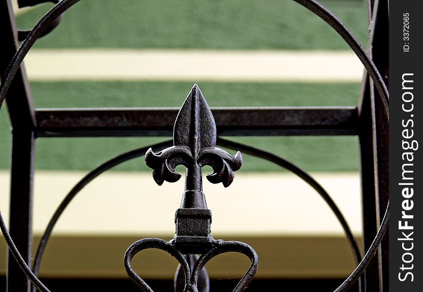 A shot of a fence with a iron spike and lines and Shapes.