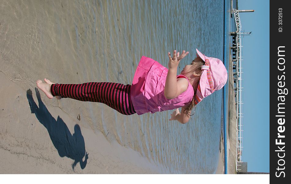 Little girl jumping for joy on the beach. Little girl jumping for joy on the beach