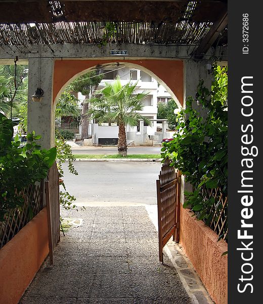 A pathway exit with plants and wooden details