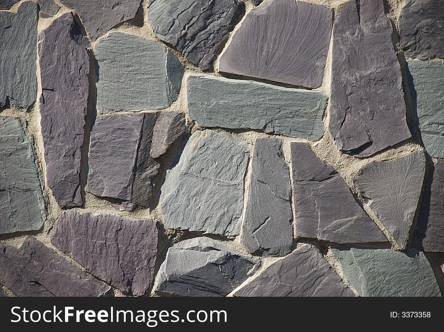 A thick textured slate or shale rock wall or path in a crazy random pattern. A thick textured slate or shale rock wall or path in a crazy random pattern