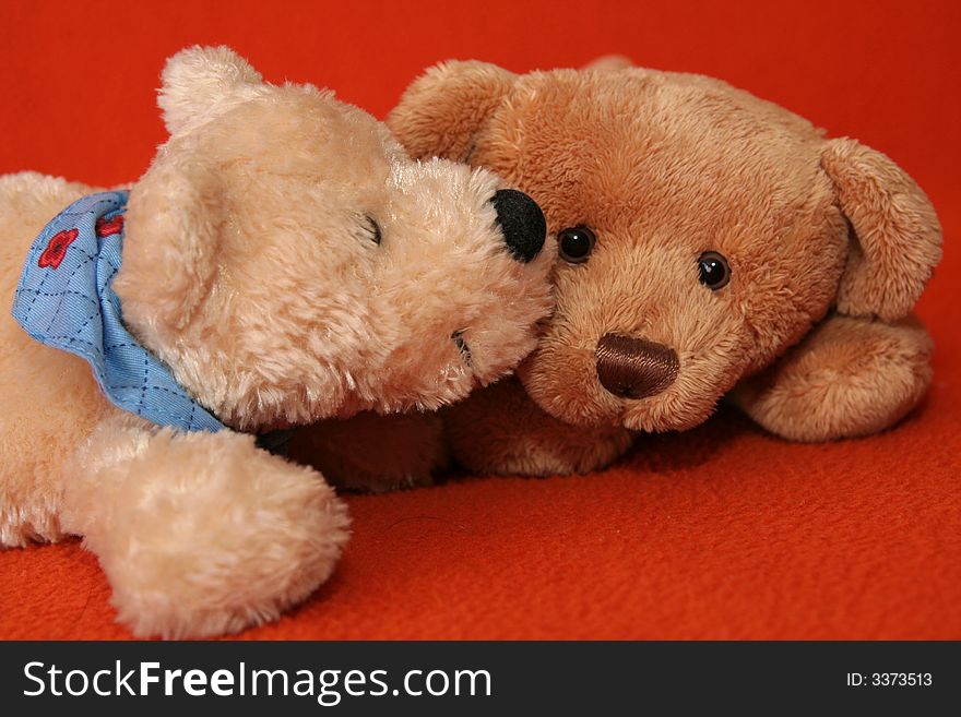 Teddy bears against dark orange background. Teddy bears against dark orange background