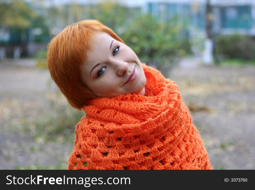 Young red-haired woman in red scarf