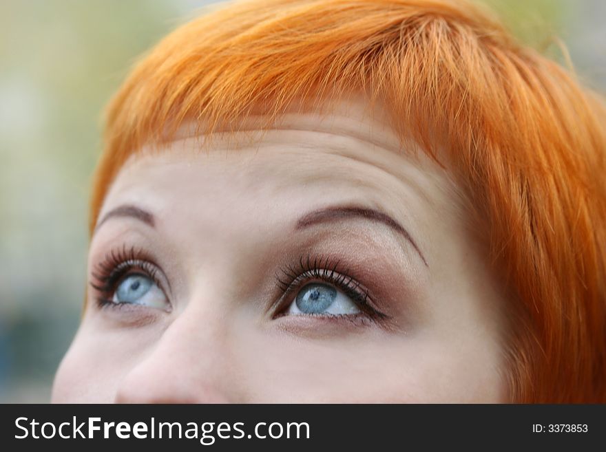 Blue eyes of red-haired woman