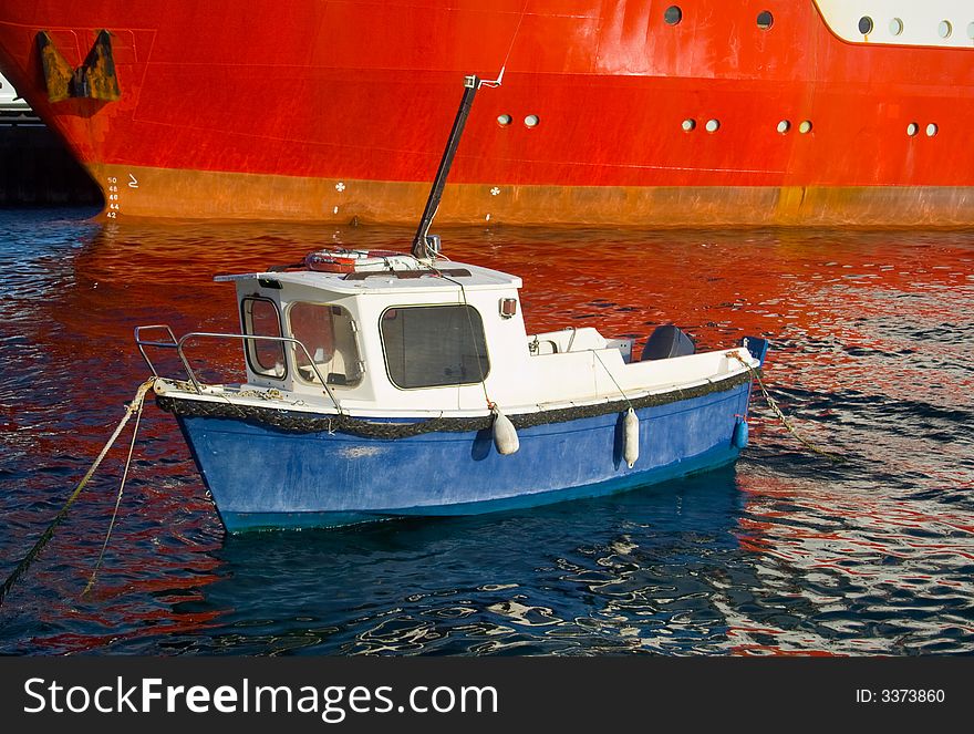 Contrasting vessels in a small harbour. Contrasting vessels in a small harbour