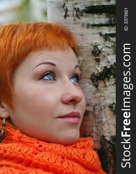 Young red-haired woman in red scarf. Young red-haired woman in red scarf