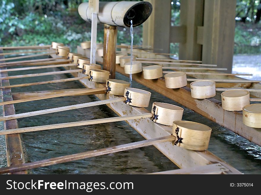 Wooden made cups are used by visitors of the Meiji Jingu Temple in Tokyo, Japan, to wash their hands and purify themselves before entering. Wooden made cups are used by visitors of the Meiji Jingu Temple in Tokyo, Japan, to wash their hands and purify themselves before entering.