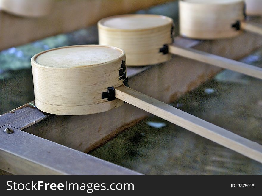 Wooden made cups are used by visitors of the Meiji Jingu Temple in Tokyo, Japan, to wash their hands and purify themselves before entering. Wooden made cups are used by visitors of the Meiji Jingu Temple in Tokyo, Japan, to wash their hands and purify themselves before entering.