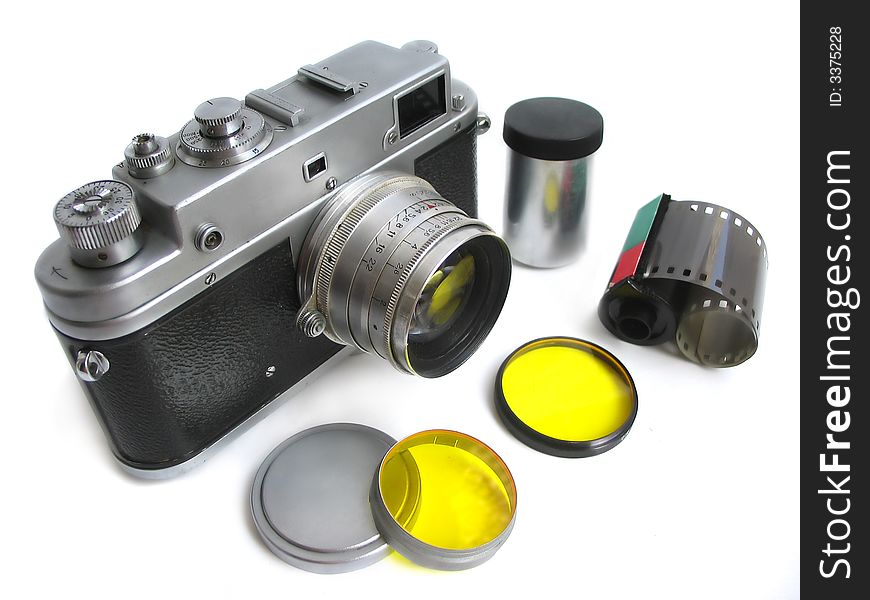 Isolated vintage camera with photofilters and negativ film on white background.