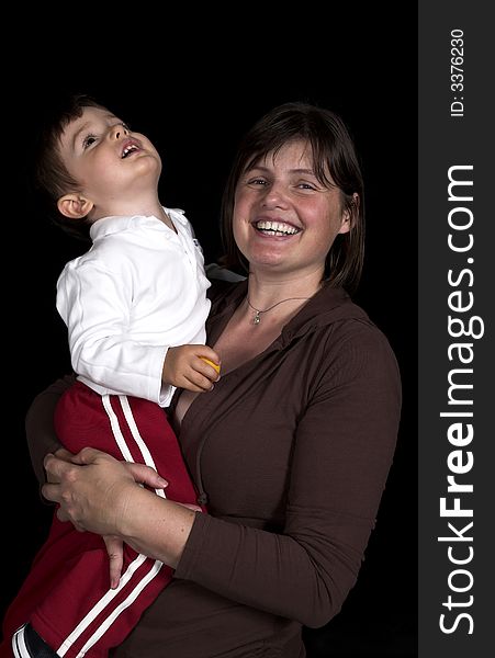 Mother ans son playing over black backdrop