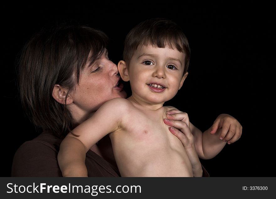 Mother ans son playing over black backdrop