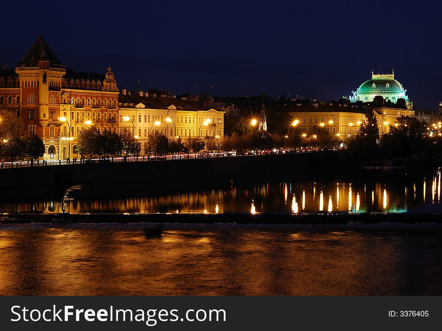 Prague at night with reflection on the water