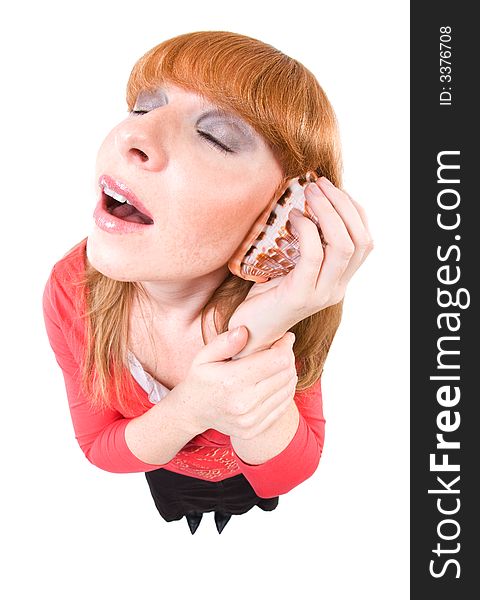 Woman holding a shell on her ear and dreaming for the next holidays. Overstated Fisheye-Effect. Isolated on white. Woman holding a shell on her ear and dreaming for the next holidays. Overstated Fisheye-Effect. Isolated on white.