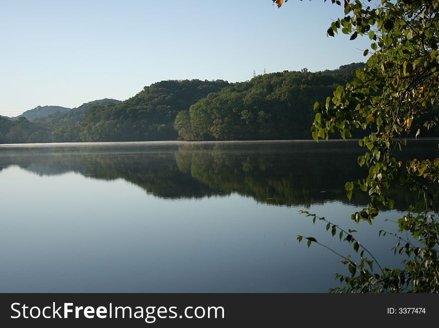 A beautiful scenic lake featuring mountains in the background reflected on the water.