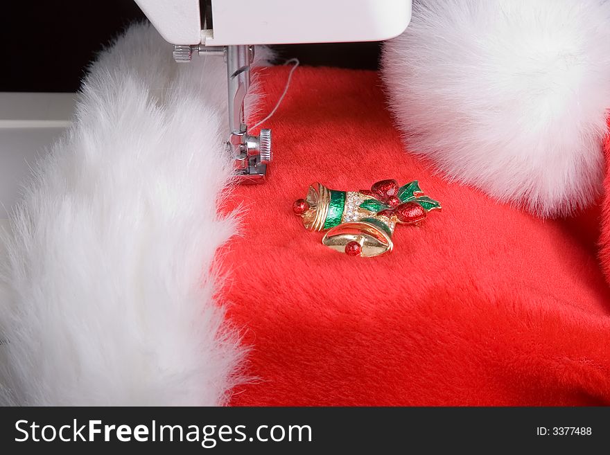 Close up capture of a sewing machine foot and Santa's hat. Close up capture of a sewing machine foot and Santa's hat.