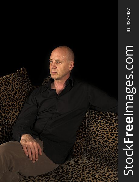 Man close up portrait shot on couch over black