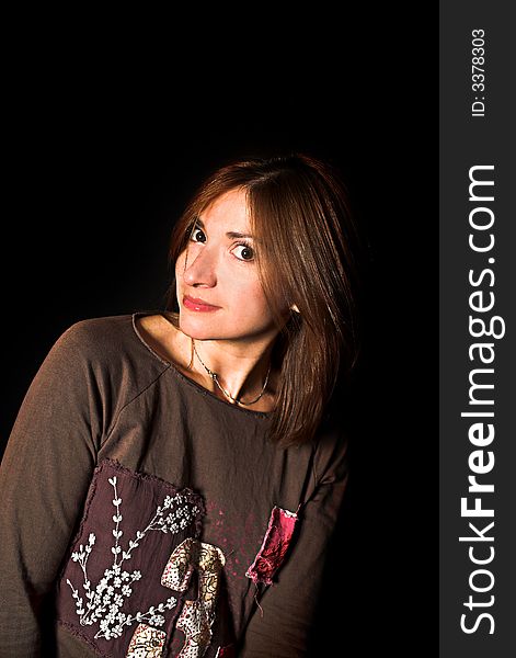 Woman with a fashion pose shot over black backdrop. Woman with a fashion pose shot over black backdrop