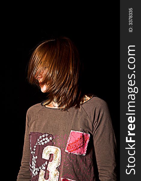 Woman with a fashion pose shot over black backdrop. Woman with a fashion pose shot over black backdrop