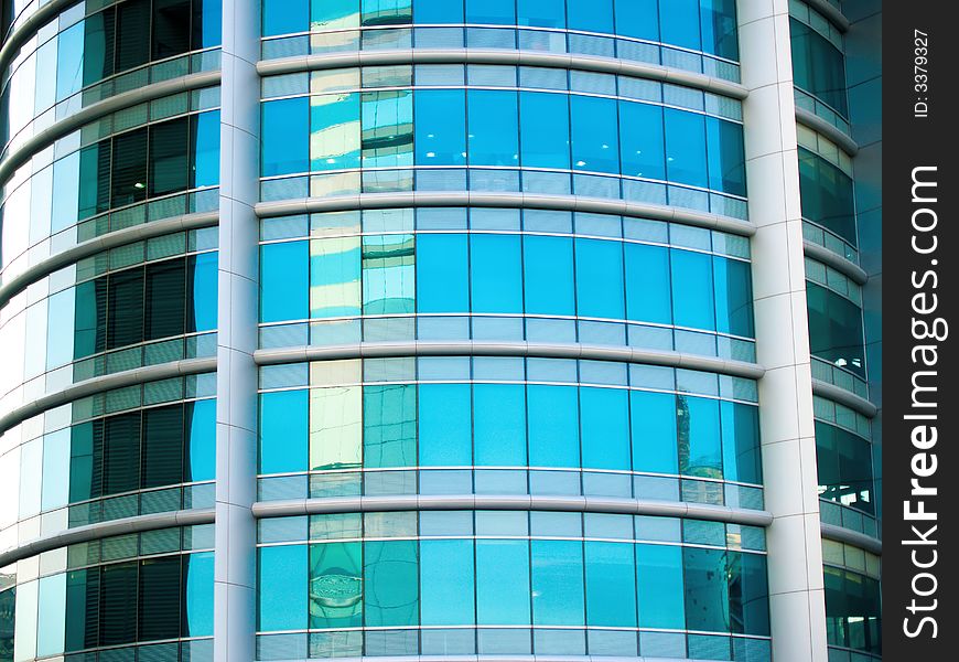 A circular facade of a modern office building in busy metropolis