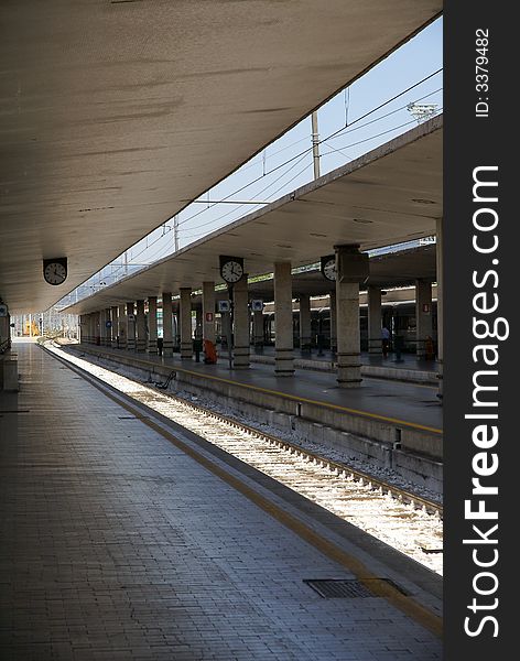 Emtpy train station in Italy with train tracks illuminated