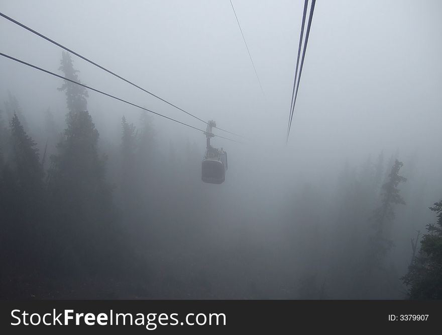 Gondola approaching in dense fog above Banff resort, Canada. Gondola approaching in dense fog above Banff resort, Canada