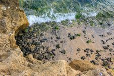Wave Rolls Onto The Rocks Of Sandy Coast Royalty Free Stock Photo