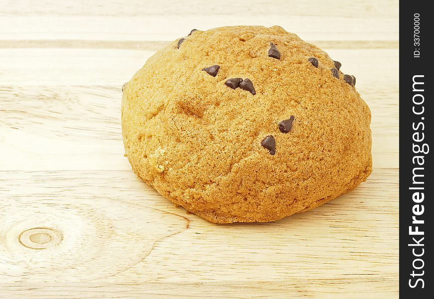 Round delicious tasty bun on wood background. Round delicious tasty bun on wood background