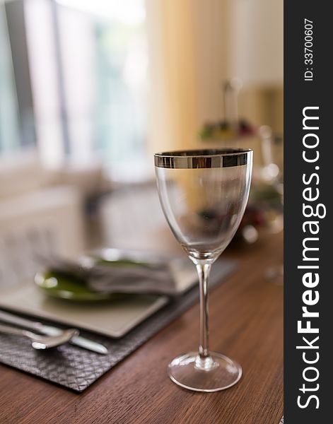 Wine glass with metallic rim on diner table