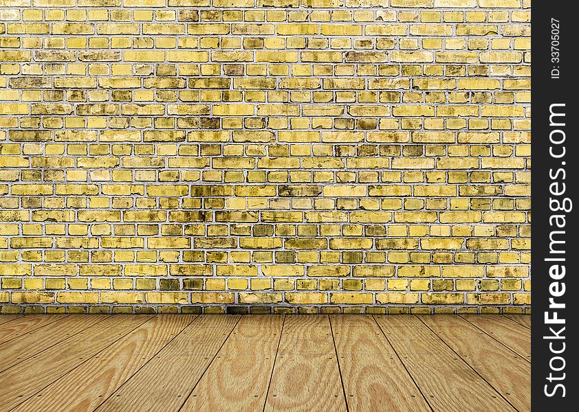 Indoor background with yellow brick wall and wooden plank floor.