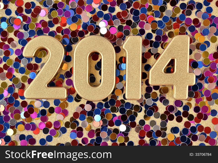 2014 year golden figures on the background of varicolored confetti