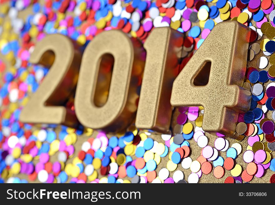2014 year golden figures on the background of varicolored confetti