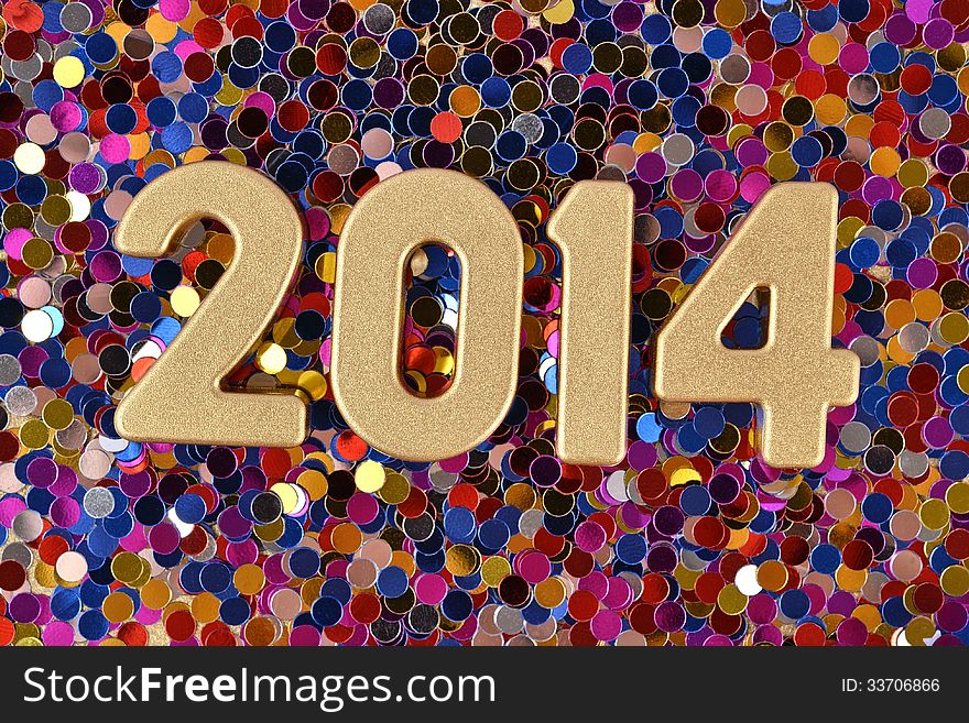 2014 year golden figures on the background of varicolored confetti