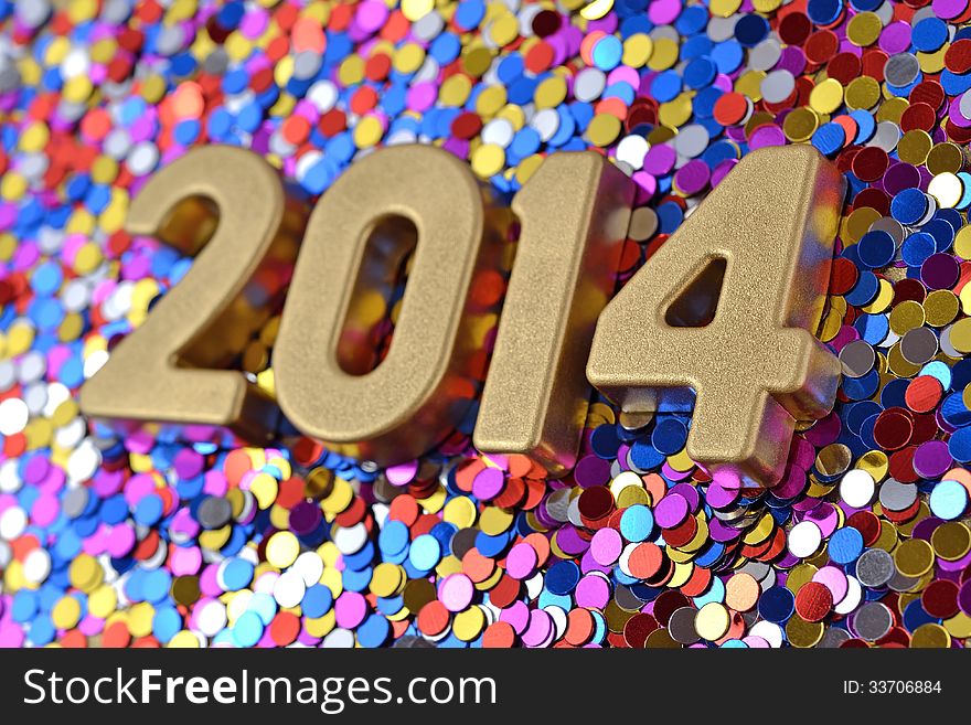 2014 year golden figures on the background of varicolored confetti