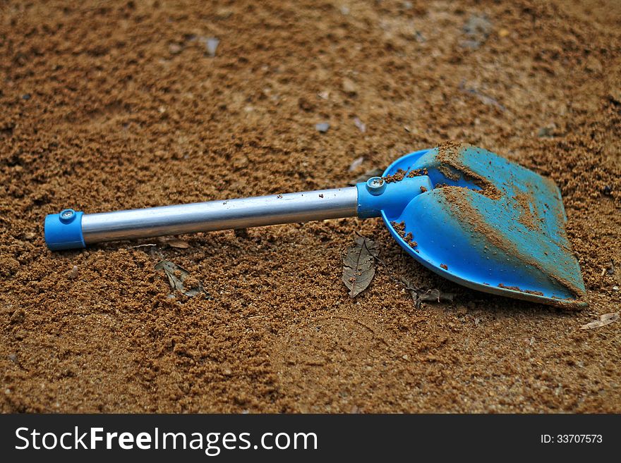 Blue spade in the sandpit. Blue spade in the sandpit