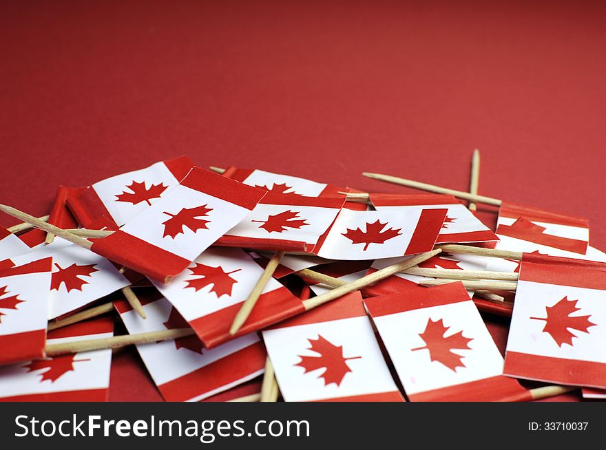 Abstract background of Canada red and white Maple Leaf national toothpick flags for national emblem or public holiday event, with copy space for your text here.