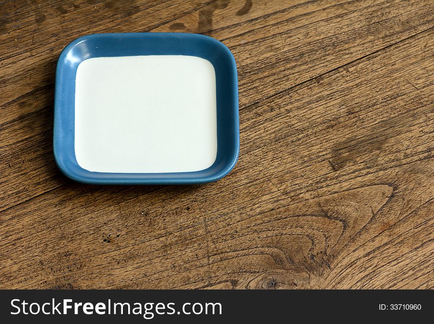 Empty square white and blue color dish on wood table