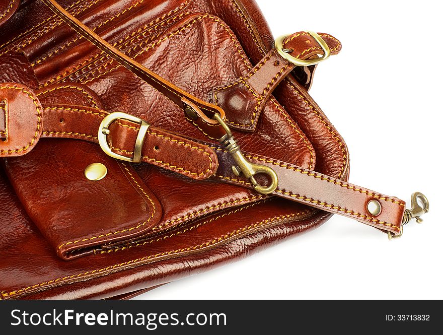 Details of Ginger Leather Traveling Bag with Pocket, Handles, Bronze Rivets and Carabiners closeup on white background. Details of Ginger Leather Traveling Bag with Pocket, Handles, Bronze Rivets and Carabiners closeup on white background