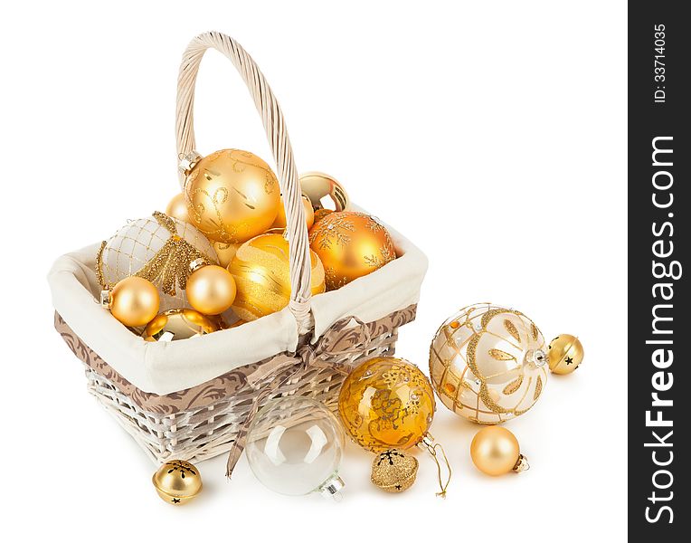 Golden Christmas balls in wicker basket isolated on white background