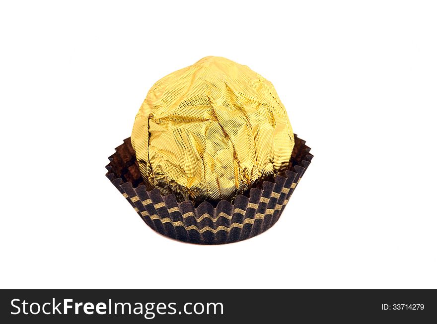 Candy wrapped in gold foil isolated